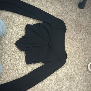 This is a black crop top ruffle shirt